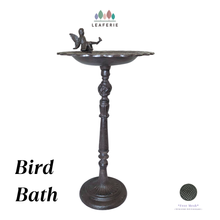 Load image into Gallery viewer, Cast Iron bird bath with a fairy figure on a white background, featuring the Leaferie brand.