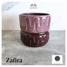 Load image into Gallery viewer, Zafira Brown ceramic planter with wavy pattern on a gray surface, branded 'LEAFERIE'.