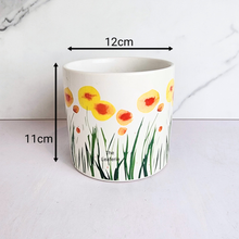 Load image into Gallery viewer, Planter with floral design and measurements on a light gray background