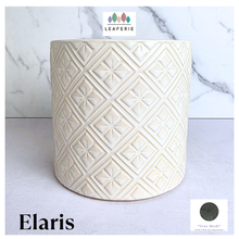 Load image into Gallery viewer, Elaris White textured ceramic planter on a marble background with 'LEAFAERIE' branding.