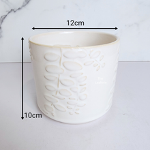 Load image into Gallery viewer, The Leaferie reidun white ceramic pot with flower motif.