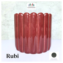 Load image into Gallery viewer, Rubi Red ceramic vase with ribbed texture on a light gray background, featuring the brand 'LEAFERIE'.