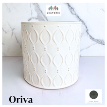Load image into Gallery viewer, An off-white ceramic planter with a textured geometric leaf pattern, shown against a white marble background. The brand name 'LEAFERIE' is visible at the top, and the product name 'Oriva' is displayed at the bottom left.