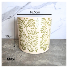 Load image into Gallery viewer, Selora Decorative planter with green floral pattern on a gray surface, featuring the brand 'LEAFERIE'.