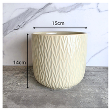 Load image into Gallery viewer, Vesper Beige ceramic pot with geometric pattern on a marble surface, featuring the LEAFAERIE brand.