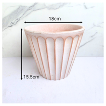 Load image into Gallery viewer, Yuno terracotta planter with ribbed design on a marble background, featuring the brand 'LEAFERIE'.