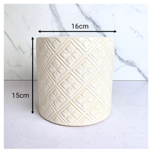 Load image into Gallery viewer, Elaris White textured ceramic planter on a marble background with 'LEAFAERIE' branding.