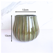 Load image into Gallery viewer, Zyra Green ceramic vase with striped pattern on a white background, featuring the brand 'LEAFERIE'.