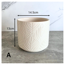 Load image into Gallery viewer, Ovelle Two white ceramic planters with leaf pattern on a marble surface, featuring the brand 'LEAFERIE'.