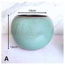 Load image into Gallery viewer, Ares Two green ceramic pots on a white marble surface with 'LEAFAERIE' branding.