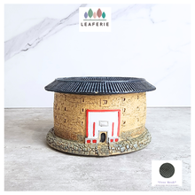 Load image into Gallery viewer, Decorative stone house with a black roof on a light wooden surface, branded with 'LEAFERIE'.