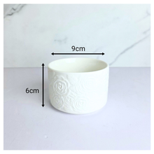 Load image into Gallery viewer, Orra White ceramic pot with textured design on a light gray background, featuring the brand 'LEAFERIE'.