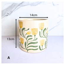 Load image into Gallery viewer, Tierra Decorative pot with floral design on a marble background, featuring the brand 'LEAFERIE'.