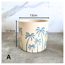 Load image into Gallery viewer, Arbor planters with palm tree design on a marble surface, featuring the Leaferie brand.