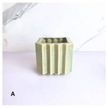 Load image into Gallery viewer, Rosin square ceramic planters with striped design on a marble surface, featuring the brand 'LEAFERIE'.