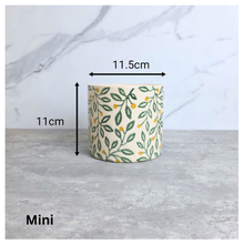 Load image into Gallery viewer, Aurelia Decorative pot with leaf pattern on a marble surface, featuring the brand 'LEAFAERIE'.