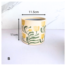 Load image into Gallery viewer, Tierra Decorative pot with floral design on a marble background, featuring the brand 'LEAFERIE'.