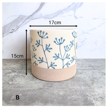Load image into Gallery viewer, Evie floralCylindrical fabric basket with blue floral patterns on a light background, featuring the brand 'LEAFERIE'.
