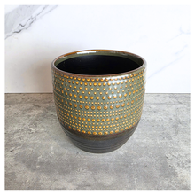 Load image into Gallery viewer, Lowell pot with gold and black design on a gray surface, featuring the Leaferie brand.