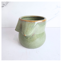 Load image into Gallery viewer, Green ceramic mug with a unique design on a white background