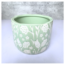 Load image into Gallery viewer, Coralie Green ceramic planter with white floral patterns on a gray background, featuring the brand 'LEAFERIE'.
