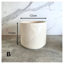 Load image into Gallery viewer, Ovelle Two white ceramic planters with leaf pattern on a marble surface, featuring the brand 'LEAFERIE'.