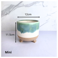 Load image into Gallery viewer, Lumea Ceramic planter with green and beige gradient on a marble background, featuring the brand 'LEAFERIE'.