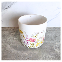 Load image into Gallery viewer, The Leaferie Rhea Two ceramic planters with floral designs on a marble surface, featuring the brand 'LEAFERIE'.
