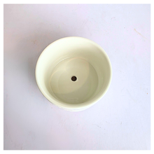Load image into Gallery viewer, Orra White ceramic pot with textured design on a light gray background, featuring the brand 'LEAFERIE'.