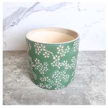 Load image into Gallery viewer, Alina pot Green plant pot with floral pattern on a wooden surface, branded 'LEAFAERIE'.