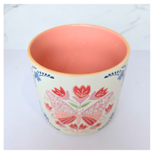 Load image into Gallery viewer, Bloomie Ceramic pot with floral and butterfly design on a marble background, featuring the brand 'LEAFERIE'.