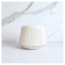 Load image into Gallery viewer, Oraya Leaferie White ribbed planter on a light gray background with Leaferie branding.