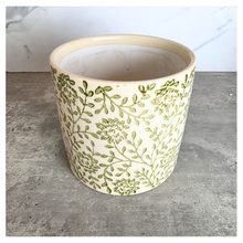Load image into Gallery viewer, Selora Decorative planter with green floral pattern on a gray surface, featuring the brand 'LEAFERIE'.