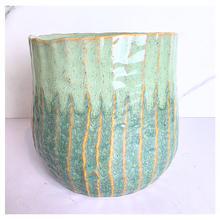 Load image into Gallery viewer, Pistachio Leaferie Green ceramic planter with gold accents on a white background, featuring the Leaferie brand
