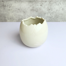 Load image into Gallery viewer, The Leaferie Maja Egg flowerpot. cream white ceramic pot. front view of designs A