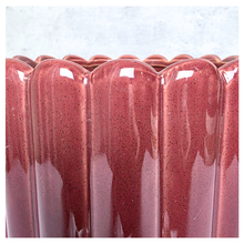 Load image into Gallery viewer, Rubi Red ceramic vase with ribbed texture on a light gray background, featuring the brand 'LEAFERIE'.