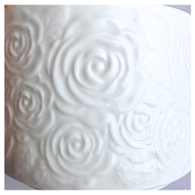 Load image into Gallery viewer, Orra White ceramic pot with textured design on a light gray background, featuring the brand 'LEAFERIE'.
