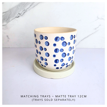 Load image into Gallery viewer, Cirra White ceramic planter with blue dot pattern on a light gray background, featuring the brand 'LEAFAERIE'.