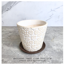 Load image into Gallery viewer, An off-white ceramic planter with a textured, embossed floral pattern, displayed on a gray stone surface against a white marble background. The brand name 'LEAFERIE' is visible at the top, and the product name 'Colette' is shown at the bottom left.