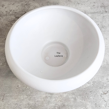 Load image into Gallery viewer, Xara ceramic flowerpot in white, black, and green with Leaferie branding.