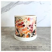 Load image into Gallery viewer, Sorel Floral-patterned candle with 'LEAFERIE' branding on a marble