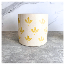 Load image into Gallery viewer, Romy Two ceramic planters with yellow patterns on a gray surface, branded 'LEAFERIE'.
