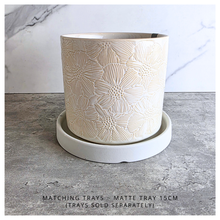 Load image into Gallery viewer, Otis White ceramic planter with floral patterns on a gray surface, featuring the LEAFERIE brand.