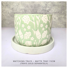Load image into Gallery viewer, Coralie Green ceramic planter with white floral patterns on a gray background, featuring the brand 'LEAFERIE'.