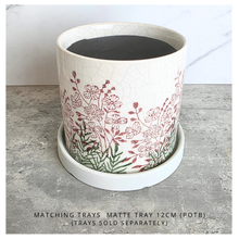 Load image into Gallery viewer, Lumelle Ceramic planter with floral design on a gray surface, featuring the brand 'LEAVERIE'.