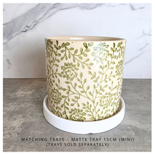 Load image into Gallery viewer, Selora Decorative planter with green floral pattern on a gray surface, featuring the brand 'LEAFERIE'.