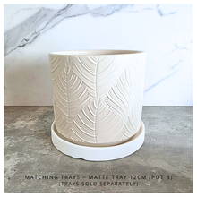 Load image into Gallery viewer, Ovelle Two white ceramic planters with leaf pattern on a marble surface, featuring the brand 'LEAFERIE'.