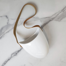 Load image into Gallery viewer, The Leaferie PAtina hanging planter. material ceramic.white colour with leather strap. no drainage hole. front view