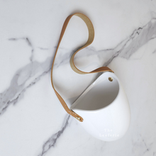 Load image into Gallery viewer, The Leaferie PAtina hanging planter. material ceramic.white colour with leather strap. no drainage hole. front view