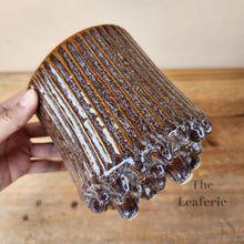 Load image into Gallery viewer, The Leaferie Ide pot. purple ceramic pot with studs at the bottom.